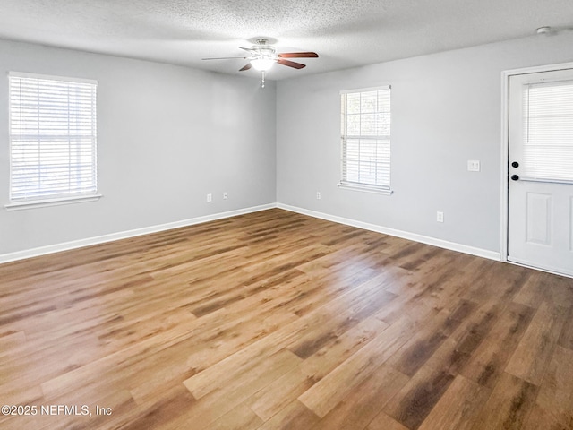 spare room with a textured ceiling, ceiling fan, and hardwood / wood-style flooring