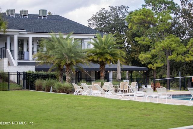 exterior space featuring a lawn, cooling unit, and fence