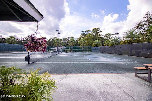 view of sport court featuring fence