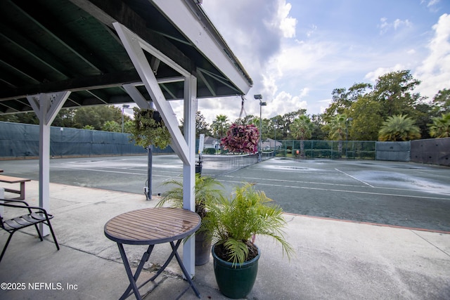 view of sport court featuring fence