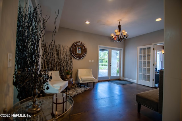 living area featuring french doors, a notable chandelier, recessed lighting, finished concrete floors, and baseboards