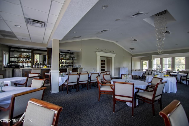 dining space with visible vents, vaulted ceiling, and carpet flooring