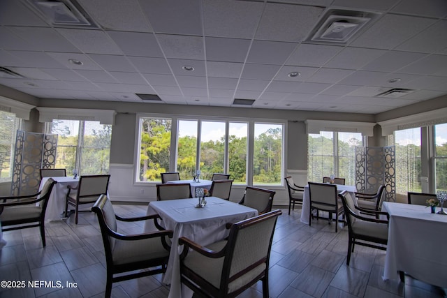 sunroom featuring visible vents and a drop ceiling