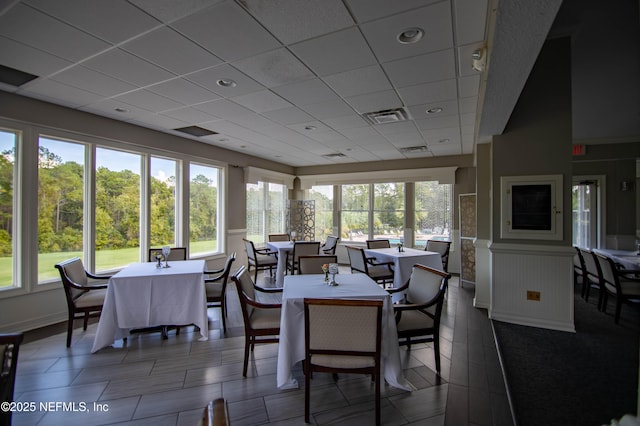 sunroom featuring a drop ceiling and visible vents