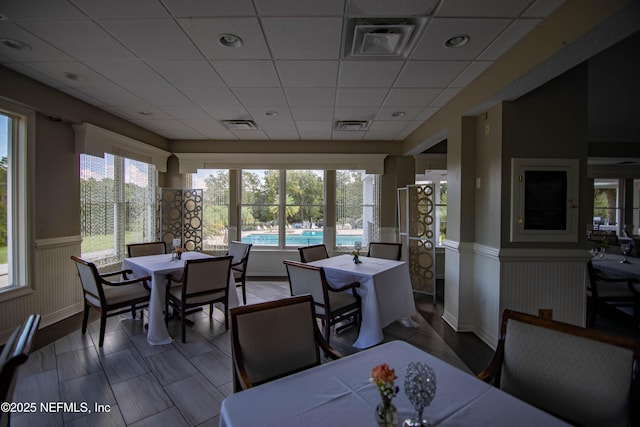 sunroom / solarium with a paneled ceiling and visible vents