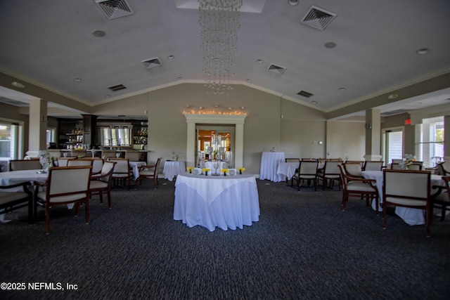 interior space with vaulted ceiling, visible vents, and crown molding