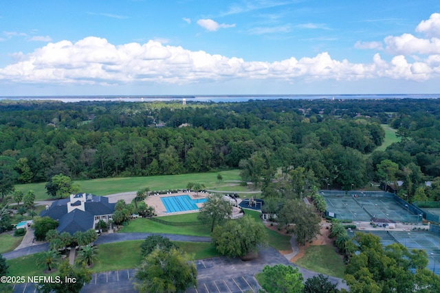 drone / aerial view featuring a forest view