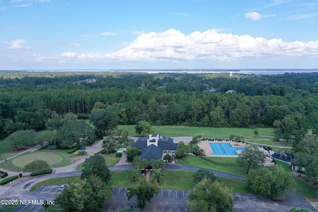 drone / aerial view featuring a wooded view