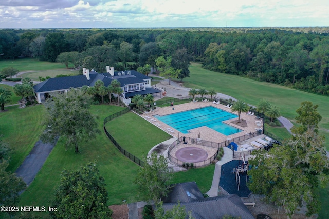 drone / aerial view featuring a wooded view