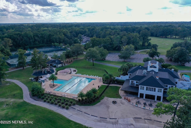 birds eye view of property with a view of trees