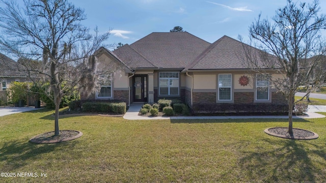 view of front of property with stone siding, a front lawn, and stucco siding