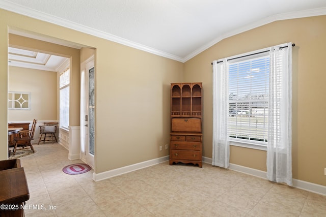 unfurnished room with ornamental molding, vaulted ceiling, and baseboards