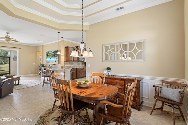 dining area featuring ceiling fan, visible vents, crown molding, and light tile patterned floors