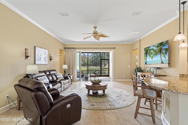 living area with light tile patterned floors, baseboards, visible vents, a ceiling fan, and ornamental molding