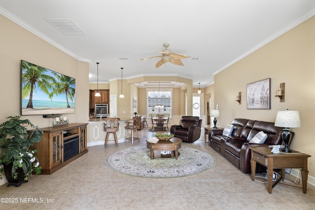 living area with ornamental molding, visible vents, ceiling fan, and light tile patterned flooring