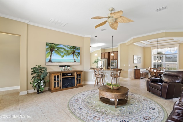 living room featuring ceiling fan, visible vents, crown molding, and light tile patterned flooring