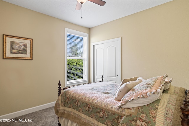 carpeted bedroom with a ceiling fan, baseboards, and a closet