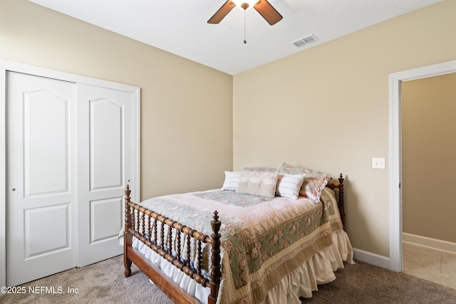 carpeted bedroom with baseboards, visible vents, ceiling fan, and a closet