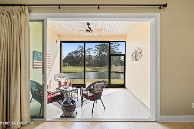 interior space featuring a water view and a ceiling fan