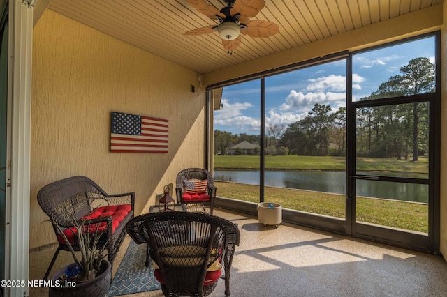 sunroom featuring a water view, wooden ceiling, and ceiling fan