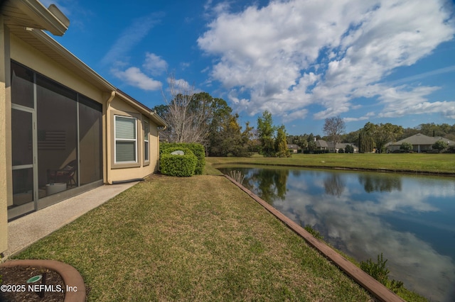 view of yard with a water view and a sunroom