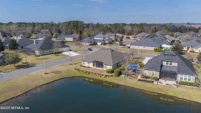 birds eye view of property with a water view and a residential view