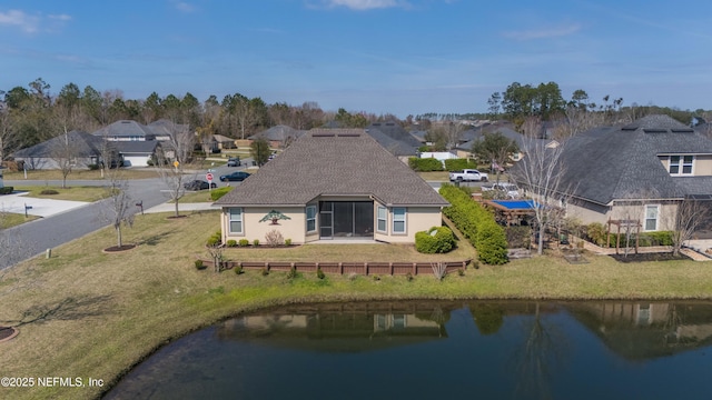 birds eye view of property with a residential view and a water view