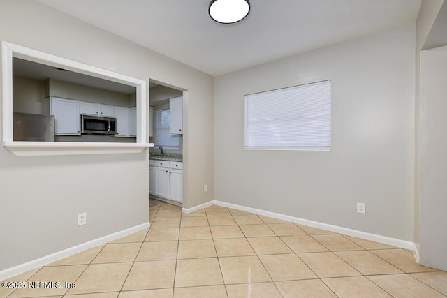 tiled spare room with sink