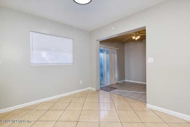 tiled empty room with ceiling fan