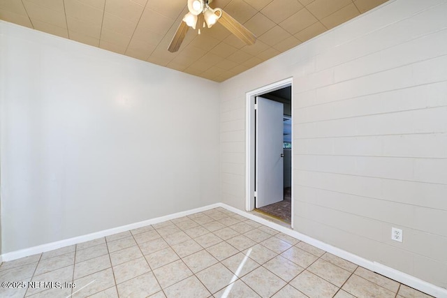 unfurnished room featuring ceiling fan and light tile patterned floors