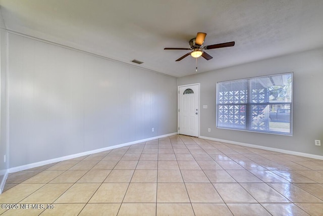 tiled empty room with ceiling fan