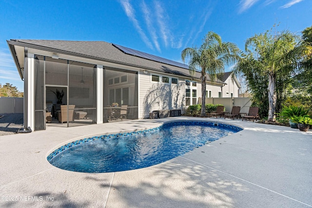 view of swimming pool featuring a patio and a sunroom