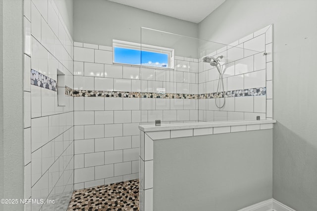 bathroom featuring tiled shower