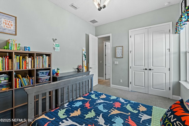 bedroom featuring light colored carpet and a closet