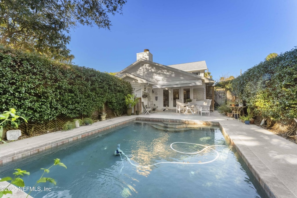 view of pool with a patio area and an outdoor structure