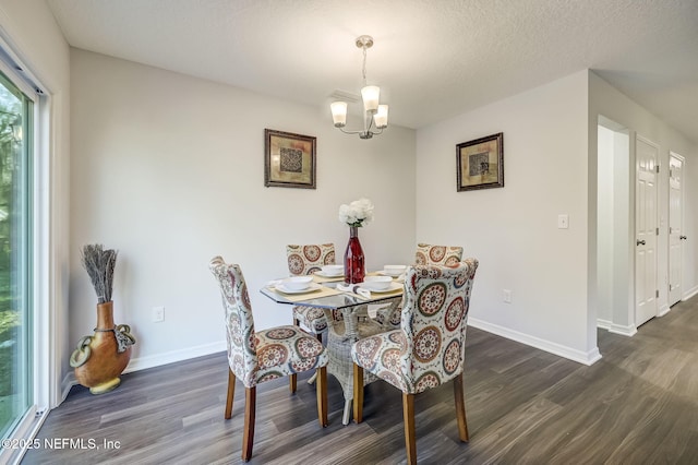 dining space with dark hardwood / wood-style flooring, a chandelier, and a textured ceiling