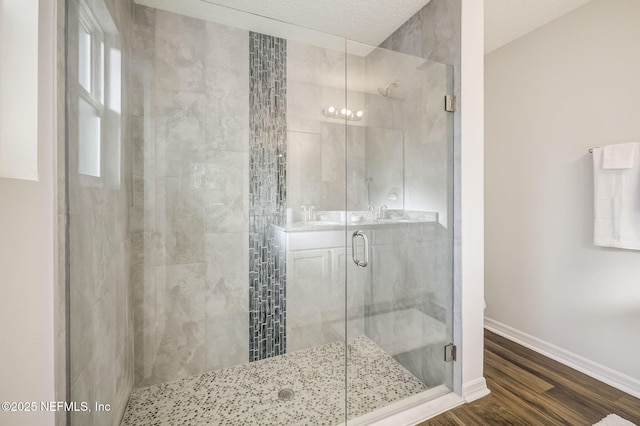 bathroom with sink, wood-type flooring, and walk in shower