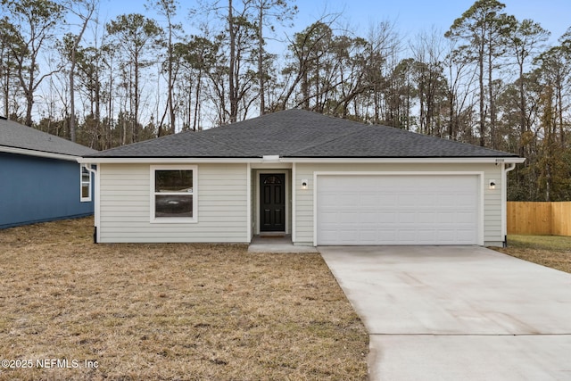 single story home with a garage and a front lawn