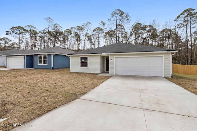 ranch-style house with a garage and a front lawn