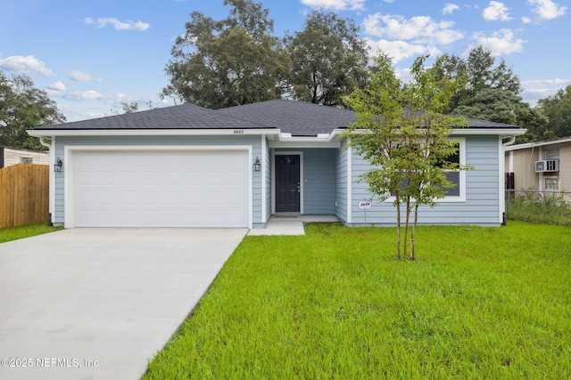 ranch-style house with a wall mounted air conditioner, a garage, and a front lawn