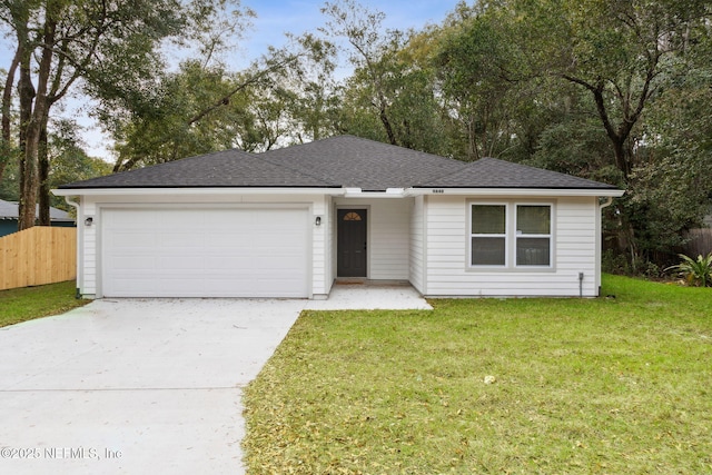 view of front of home with a garage and a front yard