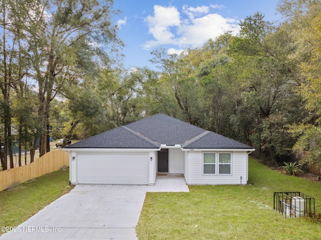 ranch-style house featuring a garage and a front yard