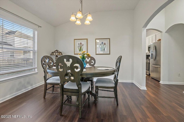 dining area featuring vaulted ceiling, an inviting chandelier, and dark wood-type flooring