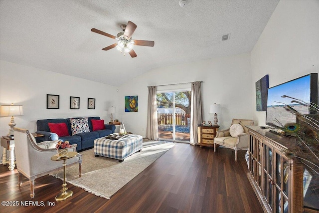 living room with ceiling fan, vaulted ceiling, dark hardwood / wood-style floors, and a textured ceiling