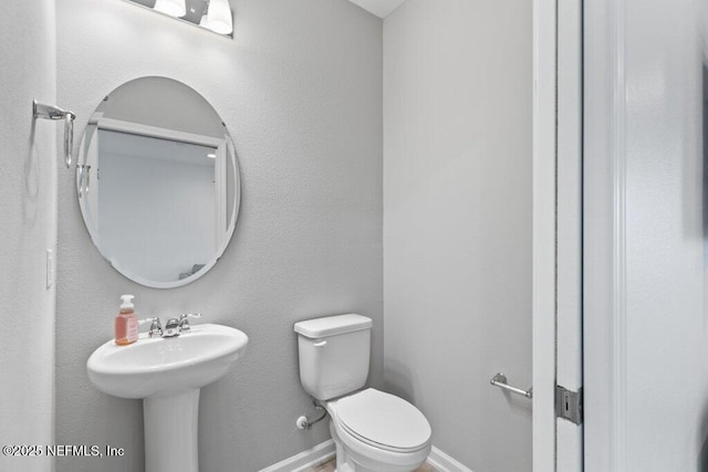 bathroom featuring toilet and sink