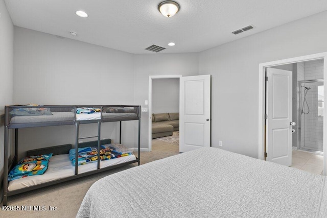 bedroom featuring a textured ceiling and ensuite bathroom