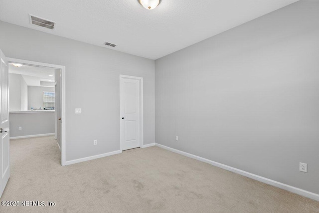 unfurnished bedroom featuring light carpet