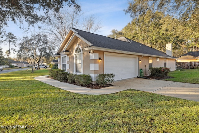 view of front of property with a front yard and a garage