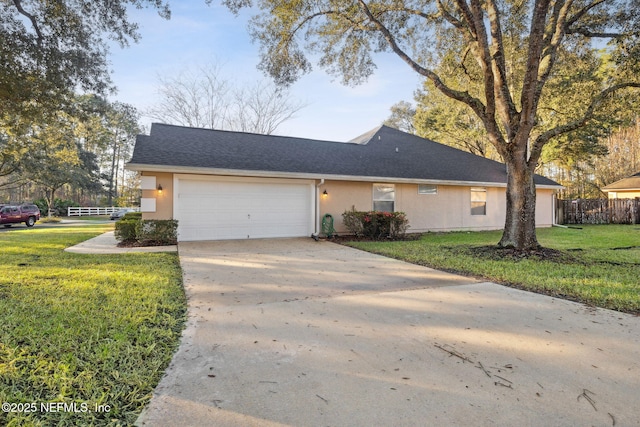 view of front facade with a front yard and a garage