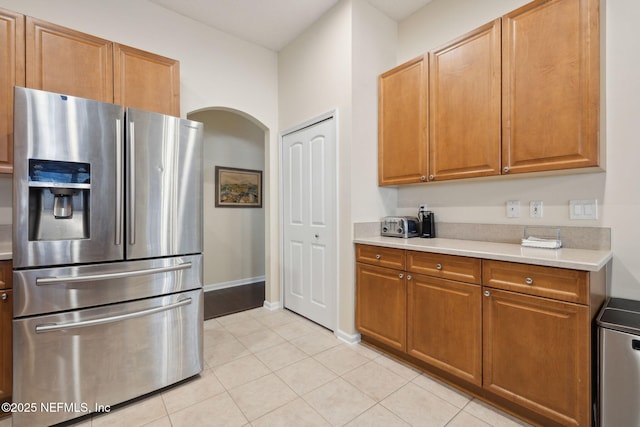 kitchen with stainless steel fridge and light tile patterned floors